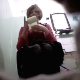 A floor mounted hidden camera records an older woman struggling to take a shit while sitting on a toilet. She did not wipe much, so she probably had little success going.